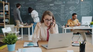 Woman talking about business stagnation solutions on phone in modern office