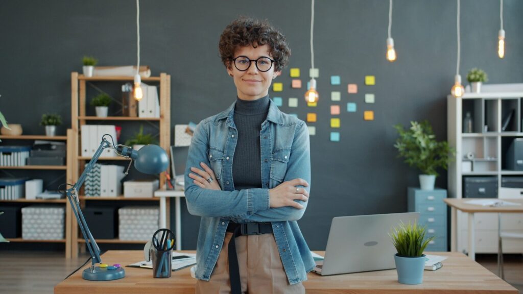 A woman entrepreneur smiles following through on business goals